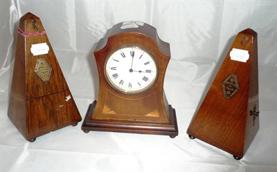 Lot 44 - Mahogany inlaid shaped mantel clock and two metronomes