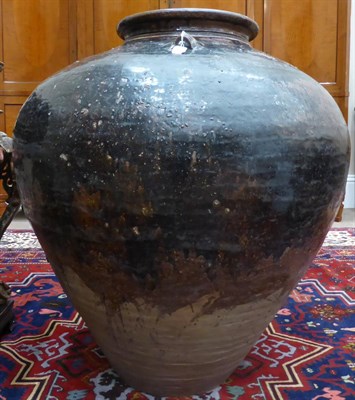 Lot 127 - A Burmese/Chinese Brown Glazed Earthenware Matavan Pot, 17th century, of ovoid form with three loop