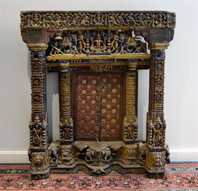 Lot 129 - A Jain Carved Teak Shrine Façade, probably Gujarat, 17th/18th century, with figure carved...