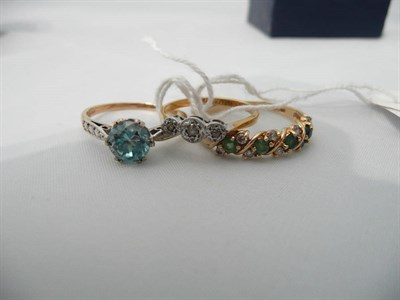 Lot 100 - A blue zircon ring, a 9ct gold emerald and diamond ring and a diamond three stone ring