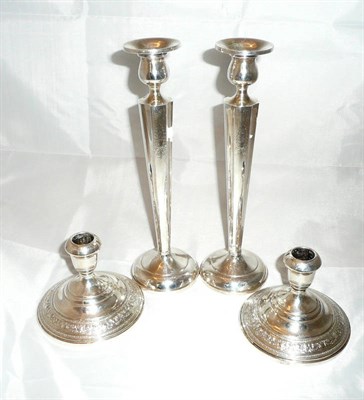 Lot 135 - Two pairs of sterling silver candlesticks