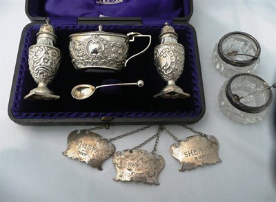 Lot 146 - A cased silver condiment set, a pair of silver mounted glass salts and spoons and a set of...