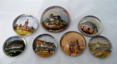 Lot 147 - Seven reverse printed glass paperweights