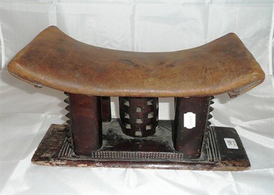 Lot 148 - An African headrest with later leather covering