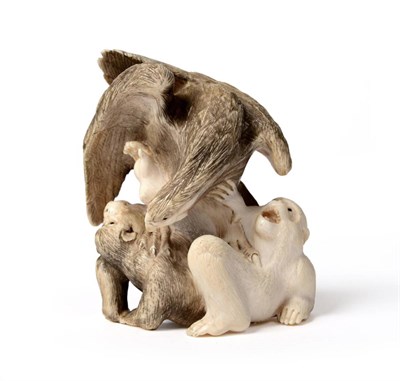 Lot 137 - A Japanese Ivory Okimono, late 19th century, carved as an eagle attacking two monkeys, with...
