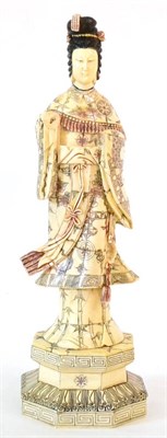 Lot 139 - A Japanese Carved and Stained Bone Okimono, 20th century, as a maiden wearing flowing robes on...
