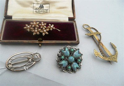 Lot 206 - A seed pearl set floral brooch, stamped '15CT', cased, a silver brooch, an anchor brooch and a...