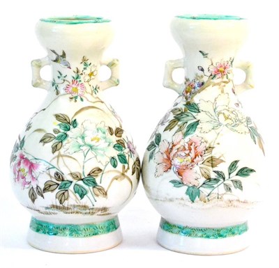 Lot 142 - A Pair of Japanese Porcelain Vases, Meiji period, of baluster form with bamboo handles, painted...