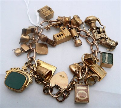 Lot 223 - A curb link charm bracelet hung with 23 charms