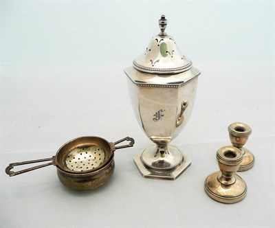 Lot 228 - A silver pedestal sugar caster, a silver tea strainer and stand and a pair of silver dwarf...