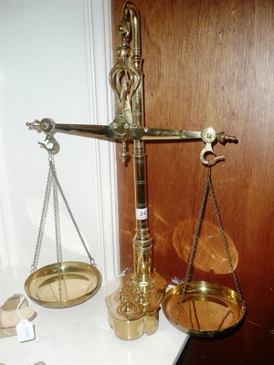 Lot 242 - A set of Librasco brass beam scales with weights set into the shaped base