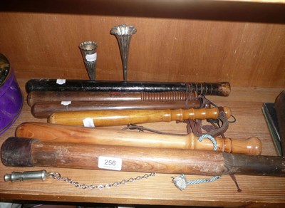 Lot 256 - Five wooden truncheons, another made from an oar, a whistle and two silver vases