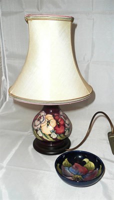 Lot 287 - A Moorcroft table lamp and shade decorated with pansies and a Moorcroft small bowl decorated...