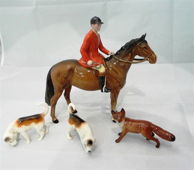 Lot 300 - A Beswick figure of a huntsman on a bay horse, two hounds and a fox