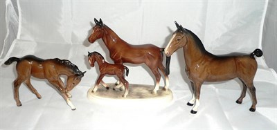 Lot 301 - A Beswick figure of a Hackney horse, a bay foal and a Continental figure group of a mare and foal