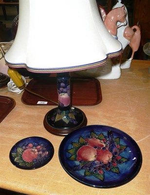 Lot 306 - A Walter Moorcroft `Finches' pattern candlestick lamp and shade; a similar plate and pin dish...