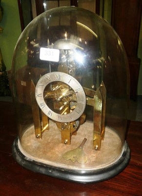 Lot 331 - A brass skeleton clock under a glass dome