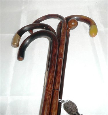 Lot 374 - Four assorted walking sticks and a childs walking stick