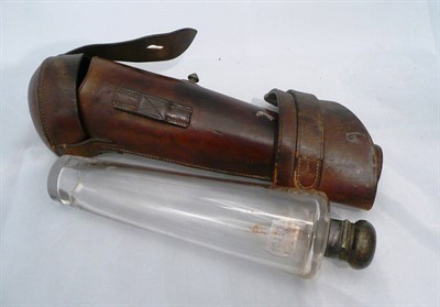 Lot 375 - A hunting flask with plated mounts in a leather holster