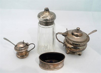 Lot 378 - A large silver mustard pot, another smaller, a silver salt with blue glass liner and a silver...