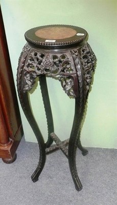 Lot 456 - A Chinese carved hardwood plant stand with a rouge marble top