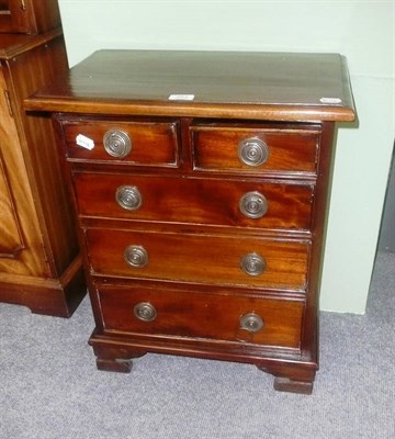 Lot 463 - A small reproduction chest of small drawers