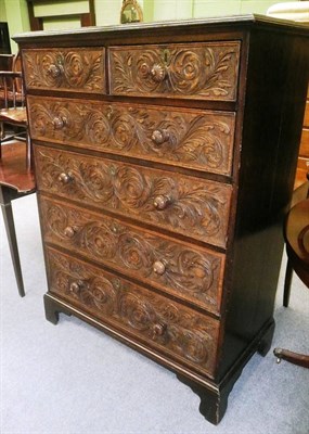 Lot 486 - A carved oak chest of drawers