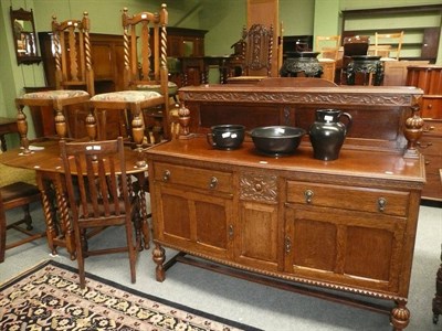 Lot 527 - An early 20th century carved oak sideboard, a gateleg table and six chairs