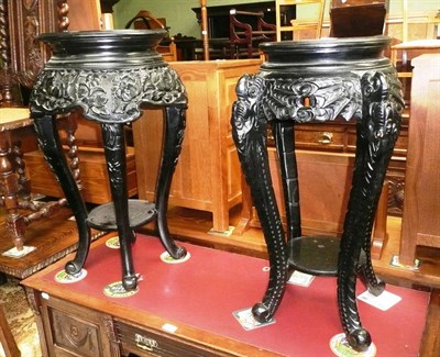 Lot 532 - Two similar carved wooden plant stands