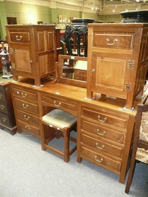 Lot 537 - An oak kneehole dressing table, a dressing mirror, a dressing stool, a pair of bedside cabinets and