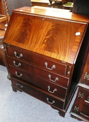 Lot 546 - A reproduction mahogany bureau, an oak occasional table, and a nest of three tables