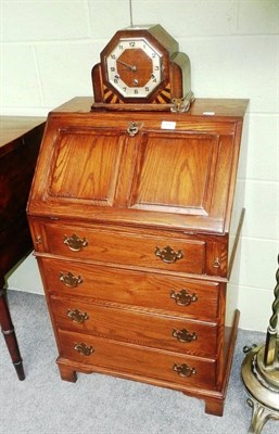 Lot 550 - A Chapmans of Siesta House oak bureau and a Art Deco oak mantel clock