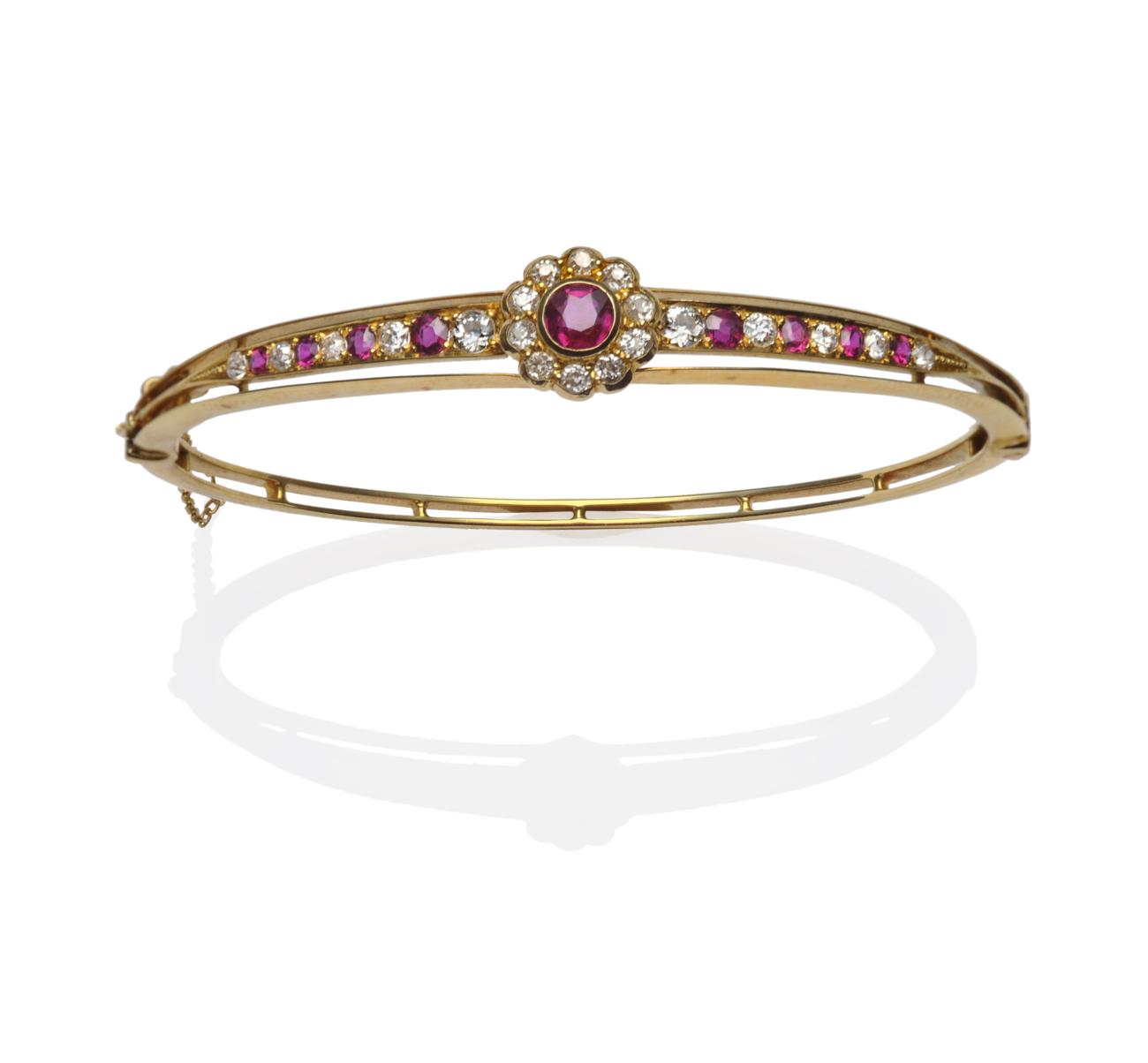 Lot 180 - A Ruby and Diamond Bangle, circa 1880, a ruby and diamond cluster in yellow rubbed over...