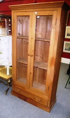 Lot 652 - A two door glazed pine bookcase