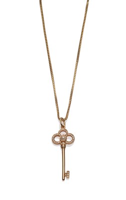 Lot 187 - An 18 Carat Gold Key Pendant, by Tiffany & Co., a diamond set key, length 4cm, on an 18 carat...