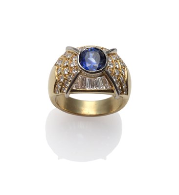 Lot 195 - A Sapphire and Diamond Dress Ring, a mixed cut sapphire within a frame inset with round...