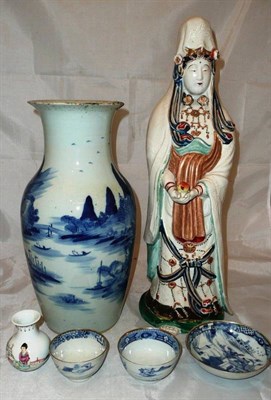 Lot 45 - A 19th century Chinese blue and white vase, a large figure, two tea bowls and a saucer and a vase