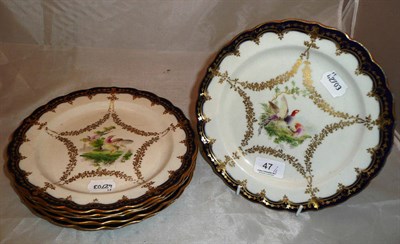 Lot 47 - A set of six Royal Worcester porcelain dessert plates, each with bird decorated vignette within...