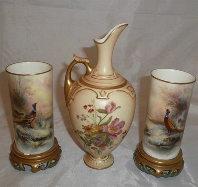 Lot 66 - A Royal Worcester blush ivory ewer, and pair of Royal Worcester beaker vases painted with pheasants