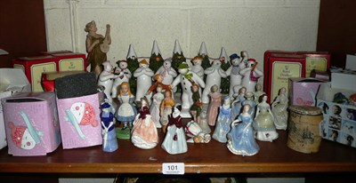 Lot 101 - A shelf of decorative ceramics including a Coalport 'Snowmen' group, Royal Doulton Bunnykins...