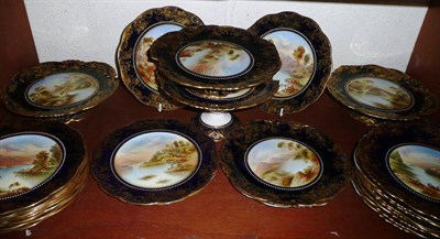 Lot 103 - An Aynsley dessert service, each piece painted with named landscapes with in a blue and gilt...
