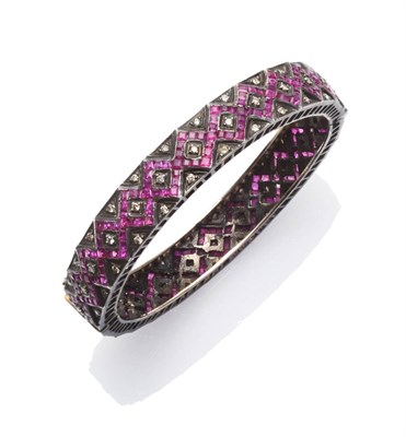 Lot 209 - An Indian Ruby and Diamond Bracelet, calibré cut rubies channel set in a geometric design,...
