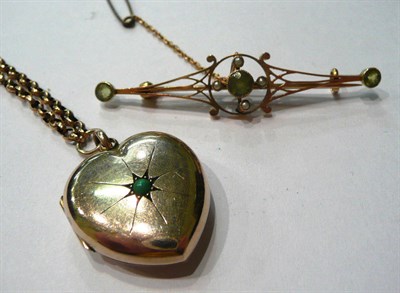 Lot 133 - A peridot and seed pearl brooch and a heart locket pendant on chain