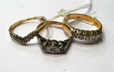 Lot 146 - A diamond five stone ring, a diamond three stone ring and a diamond wishbone ring