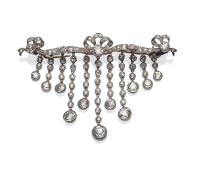 Lot 211 - A Diamond Brooch, a bar with bow motif, eleven chain linked diamond drops suspended, set with...