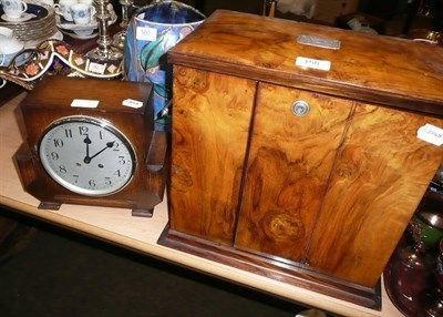 Lot 158 - A walnut smokers cabinet and mantle clock