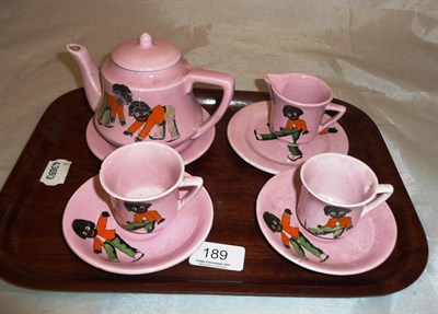 Lot 189 - A pink ground 'golly' tea set