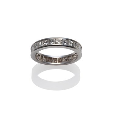 Lot 215 - A Diamond Eternity Ring, princess cut diamonds in a white channel setting, total estimated...