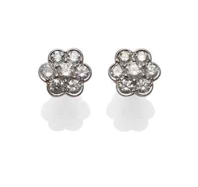 Lot 218 - A Pair of Diamond Cluster Earrings, each set with seven round brilliant cut diamonds in a white...