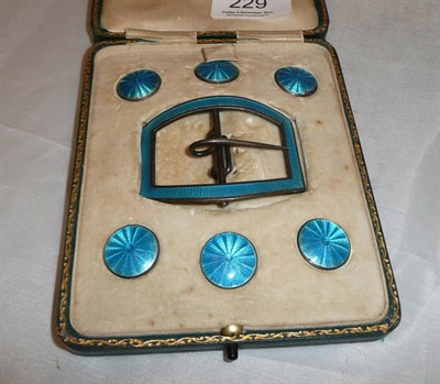 Lot 229 - Six silver and blue enamel buttons and a matching buckle (cased)
